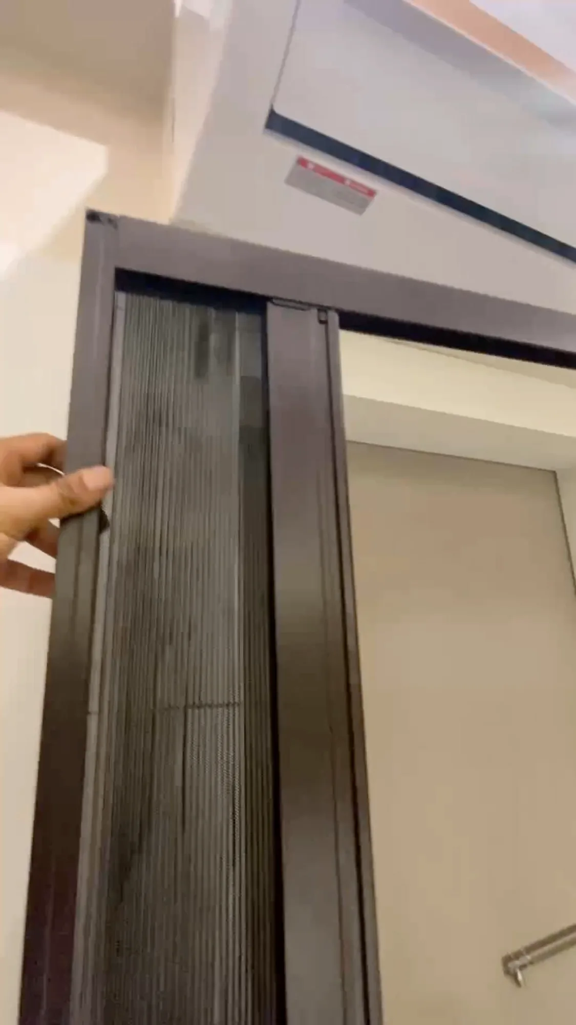 Retractable pleated mosquito mesh sliding smoothly on its aluminium track
