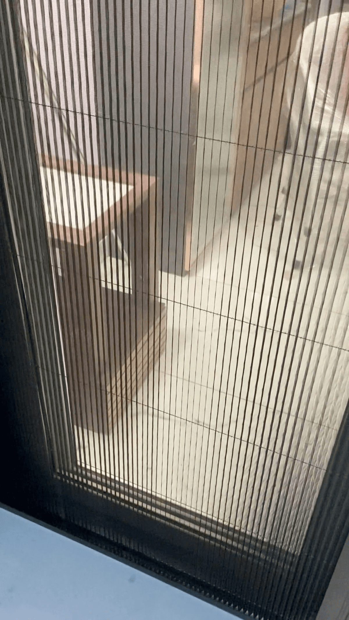 View through a pleated mosquito net showing full daylight and airflow while insects stay out